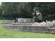 Community entrance with stone wall and landscaping at 136 Osprey Hammock Trl, Sanford, FL 32771