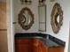 Bathroom with corner granite vanity and ornate mirrors at 136 Osprey Hammock Trl, Sanford, FL 32771