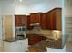 Spacious kitchen with dark wood cabinets and granite countertops at 136 Osprey Hammock Trl, Sanford, FL 32771
