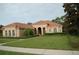 One-story home with tile roof, arched entryway, and landscaped yard at 136 Osprey Hammock Trl, Sanford, FL 32771