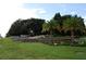 Community entrance with stone wall and landscaping at 136 Osprey Hammock Trl, Sanford, FL 32771