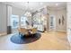 Elegant dining room with round table and gray rug at 10193 Brocksport Cir, Gotha, FL 34734
