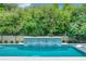 Inviting swimming pool with a beautiful water feature and lush landscaping at 10193 Brocksport Cir, Gotha, FL 34734