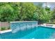 Inviting swimming pool with a beautiful water feature and lush landscaping at 10193 Brocksport Cir, Gotha, FL 34734