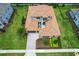 Aerial view of a house with a tile roof, a courtyard, and a landscaped yard at 10193 Brocksport Cir, Gotha, FL 34734