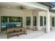 Covered patio with seating area, adjacent to the pool and outdoor kitchen at 10193 Brocksport Cir, Gotha, FL 34734