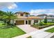 Two-story house with tile roof, double garage, and landscaped yard at 10193 Brocksport Cir, Gotha, FL 34734
