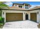 Two-car garage with olive green doors and brick pavers at 10193 Brocksport Cir, Gotha, FL 34734