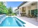 Long pool with a patio, outdoor kitchen, and dining area at 10193 Brocksport Cir, Gotha, FL 34734