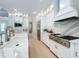 Modern kitchen with white cabinets, quartz countertops, and stainless steel appliances at 10193 Brocksport Cir, Gotha, FL 34734