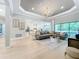 Open concept great room featuring hardwood floors, a cozy sectional sofa, and a stunning chandelier at 10193 Brocksport Cir, Gotha, FL 34734