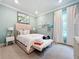 Bright bedroom with a plush bed, stylish decor, and ample natural light at 10193 Brocksport Cir, Gotha, FL 34734