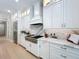 Modern kitchen with white cabinets, quartz countertops, and stainless steel appliances at 10193 Brocksport Cir, Gotha, FL 34734