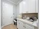 Convenient laundry room with white cabinets and ample counter space at 10193 Brocksport Cir, Gotha, FL 34734