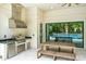 Stainless steel appliances and granite countertops highlight this outdoor kitchen at 10193 Brocksport Cir, Gotha, FL 34734