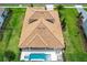 Aerial view of a home with a tile roof and pool at 10193 Brocksport Cir, Gotha, FL 34734