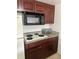 Well-equipped kitchen featuring granite countertops and dark wood cabinetry at 6337 Parc Corniche Dr # 2305, Orlando, FL 32821