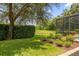 Landscaped backyard with a pond, screened pool, and fire pit at 277 Olivia Rose Ct, Lake Mary, FL 32746