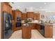 Modern kitchen with dark wood cabinets, granite countertops, and stainless steel appliances at 277 Olivia Rose Ct, Lake Mary, FL 32746