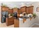 Spacious kitchen with an island, granite countertops, and wood cabinets at 277 Olivia Rose Ct, Lake Mary, FL 32746