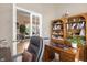 Home office features a desk, built-in shelves, and French doors leading to another room at 277 Olivia Rose Ct, Lake Mary, FL 32746