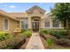 Exterior view of home featuring a paved walkway leading to the front door and a fountain at 277 Olivia Rose Ct, Lake Mary, FL 32746