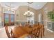 Elegant dining room features a large wooden table and chandelier at 277 Olivia Rose Ct, Lake Mary, FL 32746
