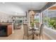 Breakfast nook in kitchen with glass-top table and chairs, overlooking the pool at 277 Olivia Rose Ct, Lake Mary, FL 32746
