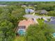 Aerial view of a house with a pool in a wooded community at 277 Olivia Rose Ct, Lake Mary, FL 32746