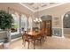 Spacious dining room with large windows, chandelier, and built-in hutch at 277 Olivia Rose Ct, Lake Mary, FL 32746