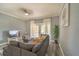 Comfortable living room with gray sectional sofa and access to a private patio at 7673 Heritage Crossing Way # 101, Reunion, FL 34747