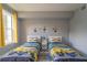 Two twin beds, Minion-themed bedding and decor, and large windows at 7673 Heritage Crossing Way # 101, Reunion, FL 34747
