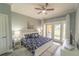 Bright main bedroom featuring a king-size bed and access to a private patio at 7673 Heritage Crossing Way # 101, Reunion, FL 34747