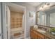 Bathroom with tub, shower, granite vanity, and diamond-patterned tile at 7673 Heritage Crossing Way # 101, Reunion, FL 34747