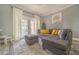Spacious living room with gray sectional sofa, sliding glass doors, and a view of patio at 7673 Heritage Crossing Way # 101, Reunion, FL 34747
