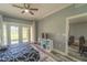 Main bedroom with king bed, private patio access, and view of the outdoors at 7673 Heritage Crossing Way # 101, Reunion, FL 34747