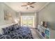 King-size bed, patio access, and plenty of natural light in this main bedroom at 7673 Heritage Crossing Way # 101, Reunion, FL 34747