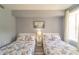 Bedroom featuring two double beds, Parisian-themed bedding, and a window at 7673 Heritage Crossing Way # 101, Reunion, FL 34747