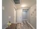 Bright entryway with wood-look floors and neutral walls at 7673 Heritage Crossing Way # 101, Reunion, FL 34747
