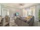 Spacious living area, gray sectional sofa, and access to the kitchen and patio at 7673 Heritage Crossing Way # 101, Reunion, FL 34747