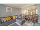 Open living room featuring a sectional sofa and kitchen views at 7673 Heritage Crossing Way # 101, Reunion, FL 34747