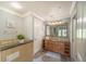 Bathroom with granite vanity and walk-in shower at 7673 Heritage Crossing Way # 101, Reunion, FL 34747
