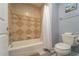 Clean bathroom with tub, shower, and neutral color scheme at 7673 Heritage Crossing Way # 101, Reunion, FL 34747