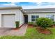 Exterior view of a charming villa with a brick pathway and well-manicured lawn at 2877 Attwater Loop, Winter Haven, FL 33884