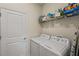 Laundry room with washer, dryer, and shelving at 2877 Attwater Loop, Winter Haven, FL 33884