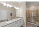 Bathroom with double sinks, walk-in shower, and grab bars at 2877 Attwater Loop, Winter Haven, FL 33884