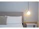 Close-up of a bedroom with a plush bed and modern lighting at 3191 Paradox Cir # 102, Kissimmee, FL 34746