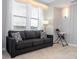Living room features a dark gray couch and a high chair at 3191 Paradox Cir # 102, Kissimmee, FL 34746
