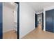 Hallway with blue doors and a view into a kitchen and a closet at 538 Windmeadows St, Altamonte Springs, FL 32701