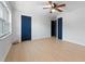 Spacious bedroom with light flooring, ceiling fan, and two blue doors at 538 Windmeadows St, Altamonte Springs, FL 32701